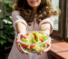 brunette-woman-eating-salad_23-2148173213